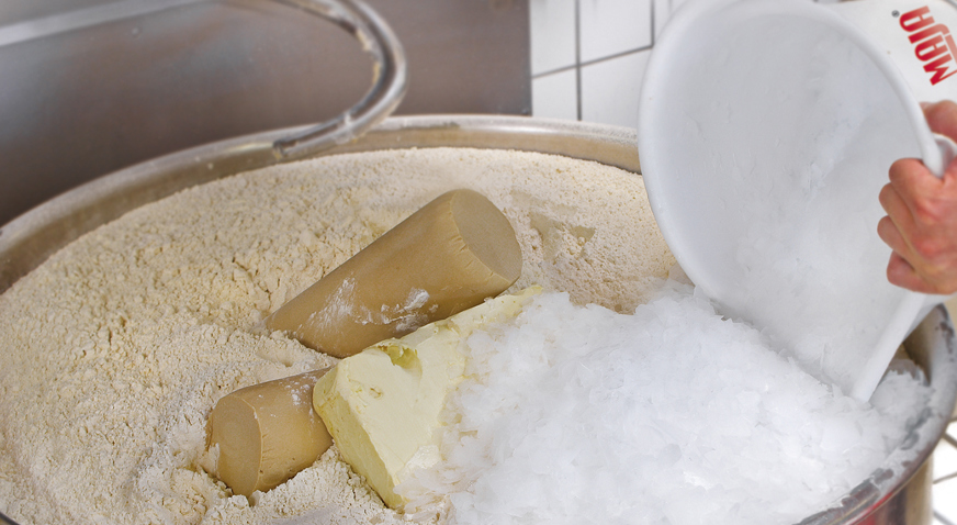 Bakeries and retail bakers use specific amounts of flake ice from a MAJA industrial ice maker to cool dough during mixing and kneading
