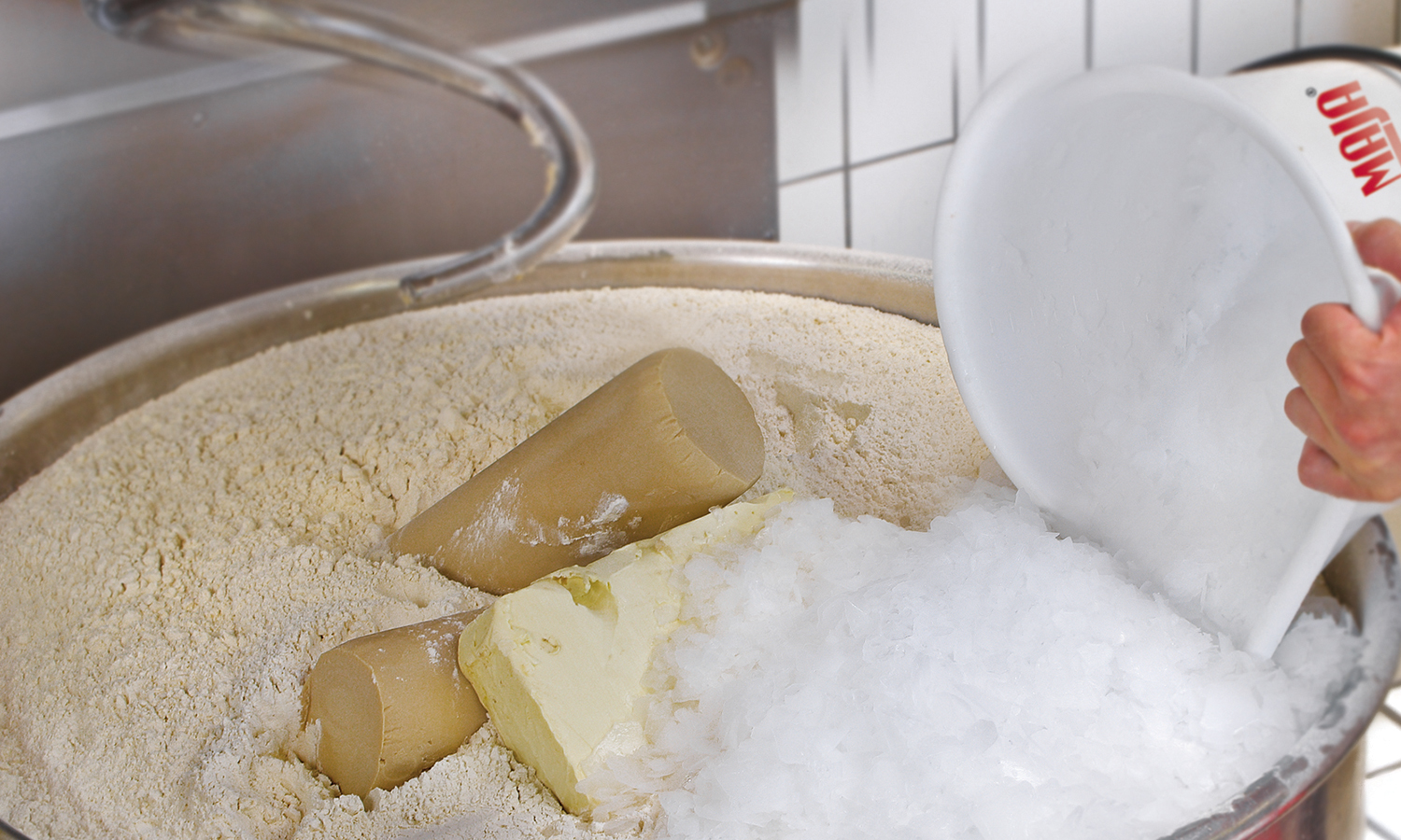 Bakeries and retail bakers use specific amounts of flake ice from a MAJA industrial ice maker to cool dough during mixing and kneading